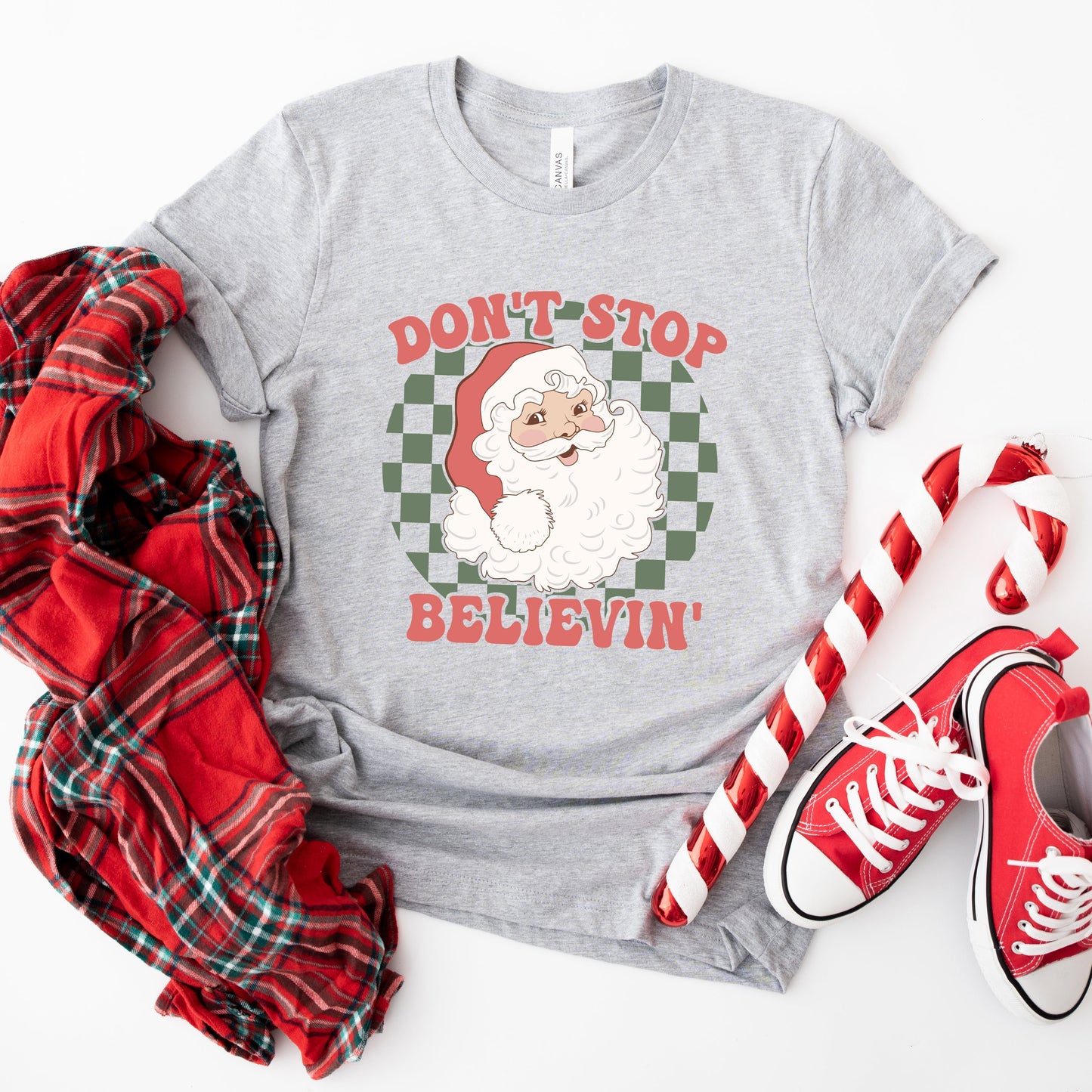 Don't Stop Believin' Santa Checkered | Short Sleeve Graphic Tee | Christmas