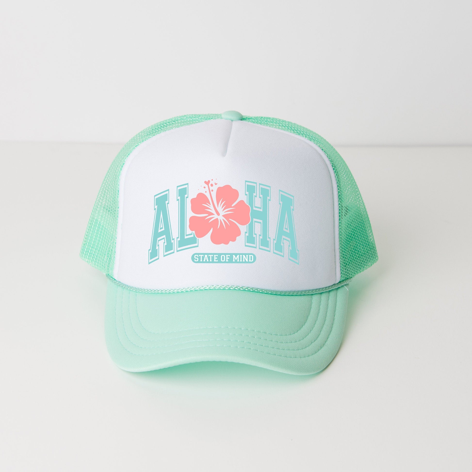 a green and white hat with a flower on it