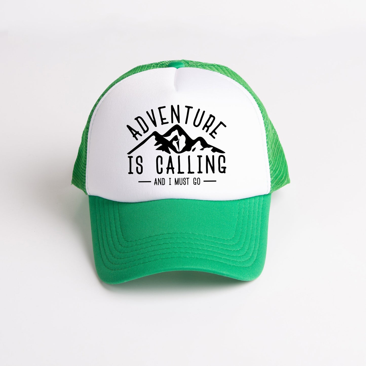 a green and white hat with the words adventure is calling printed on it