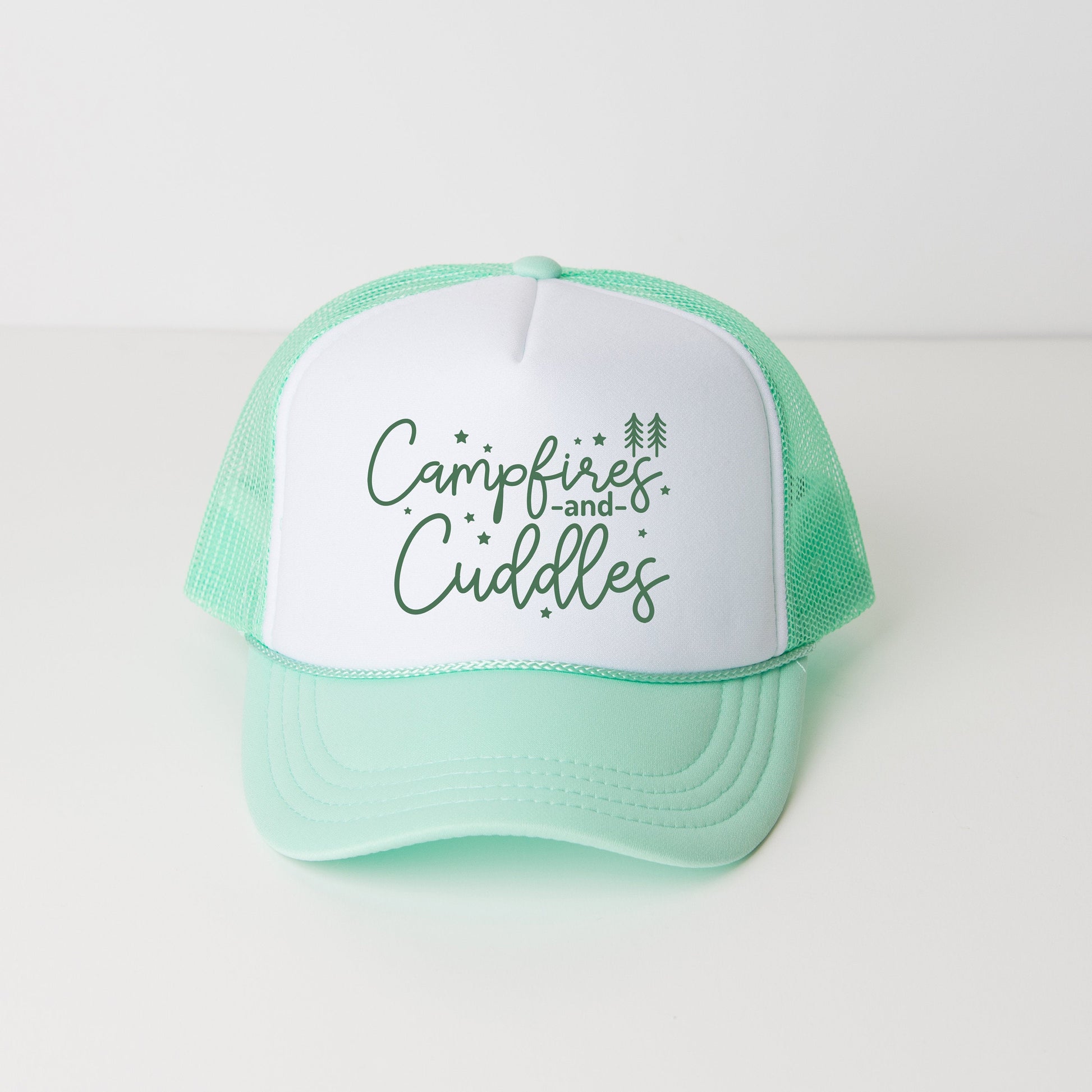 a green and white trucker hat that says campfires and cuddles