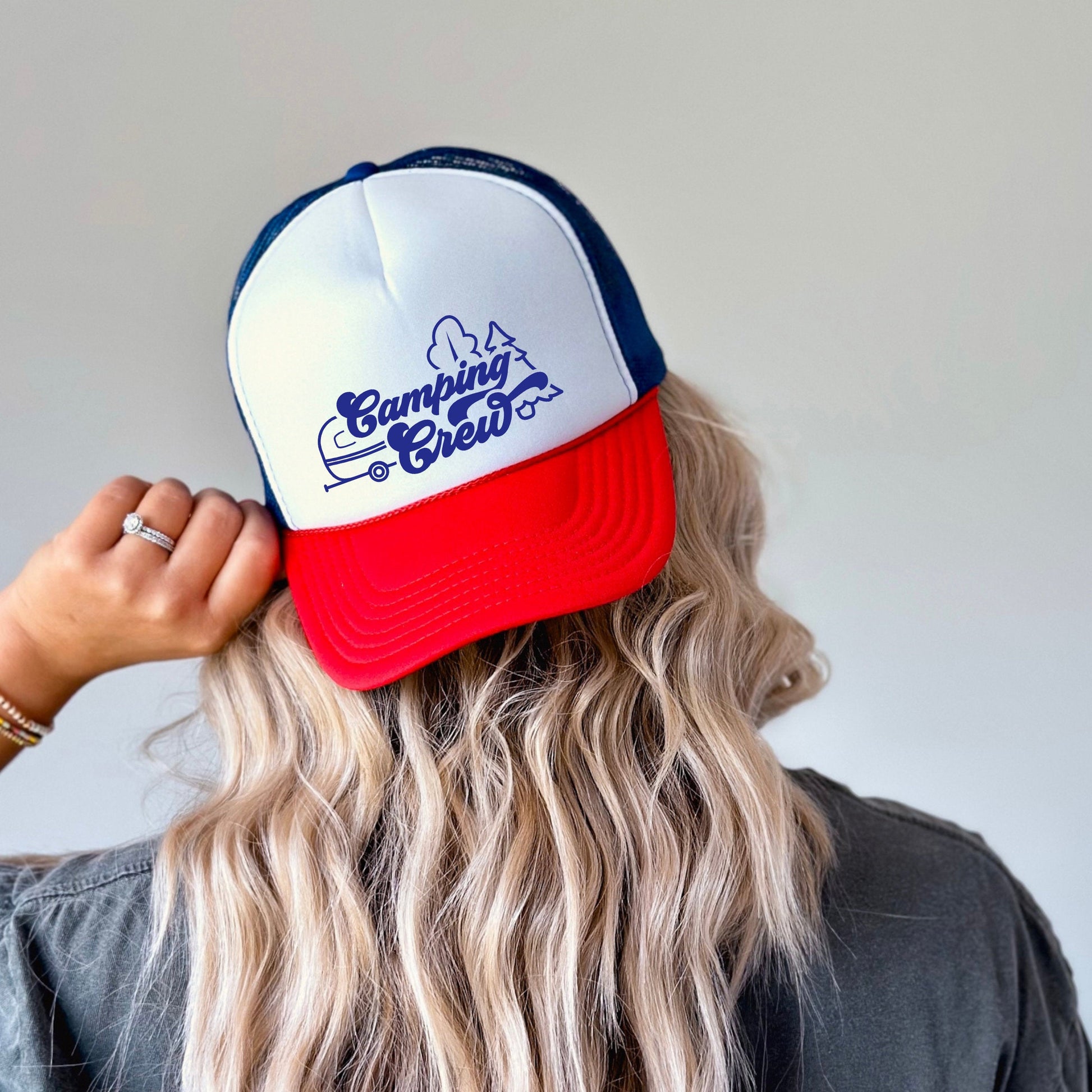 a woman with long blonde hair wearing a red, white and blue hat