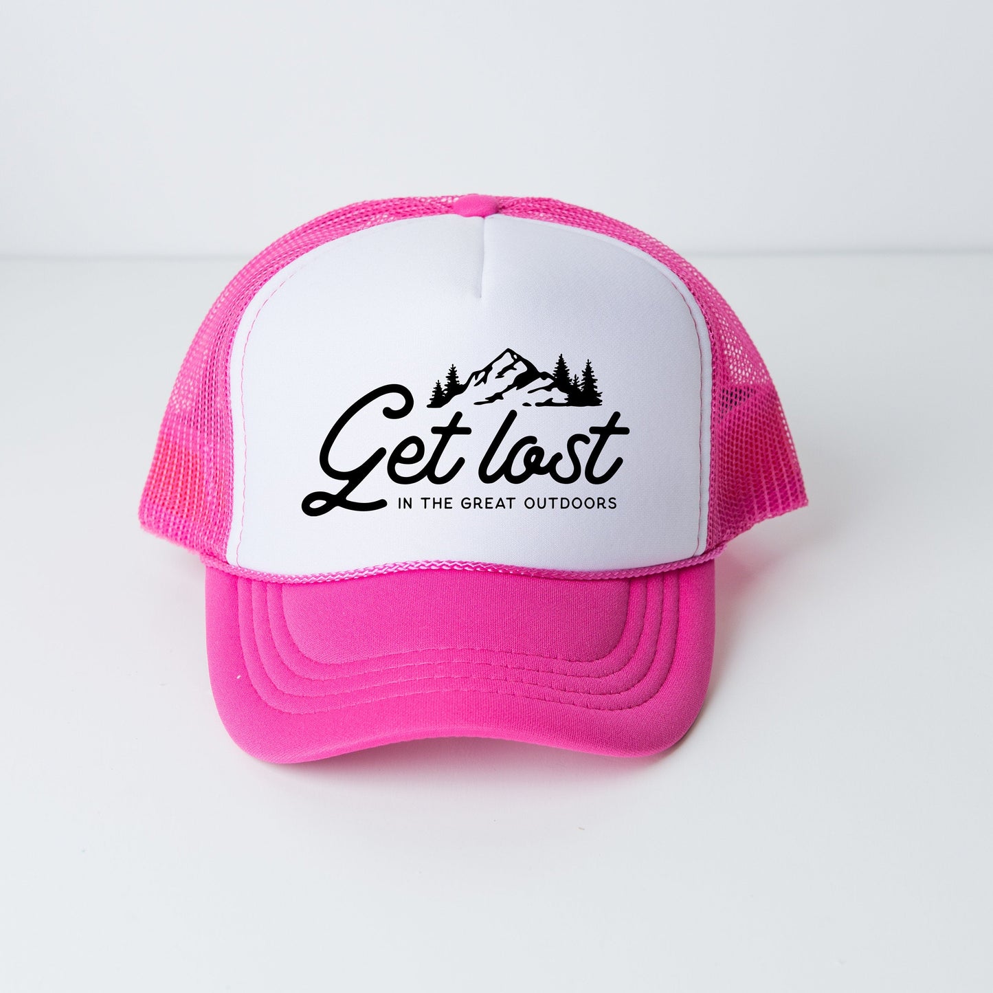 a pink and white trucker hat with the words get lost in the great outdoors