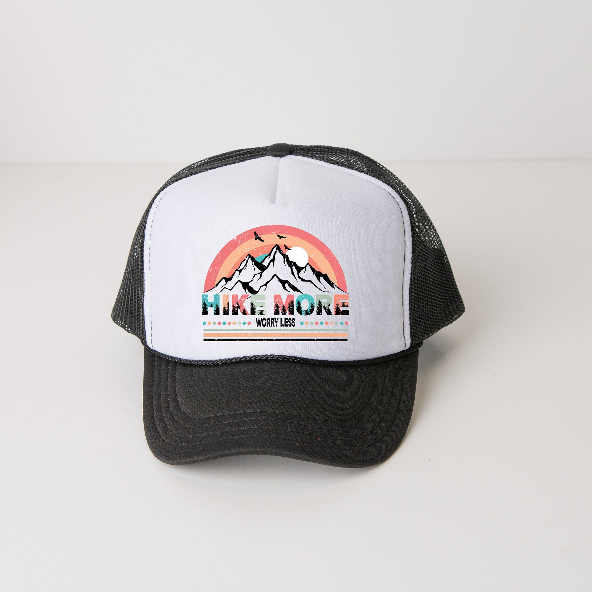 a black and white trucker hat with a mountain scene