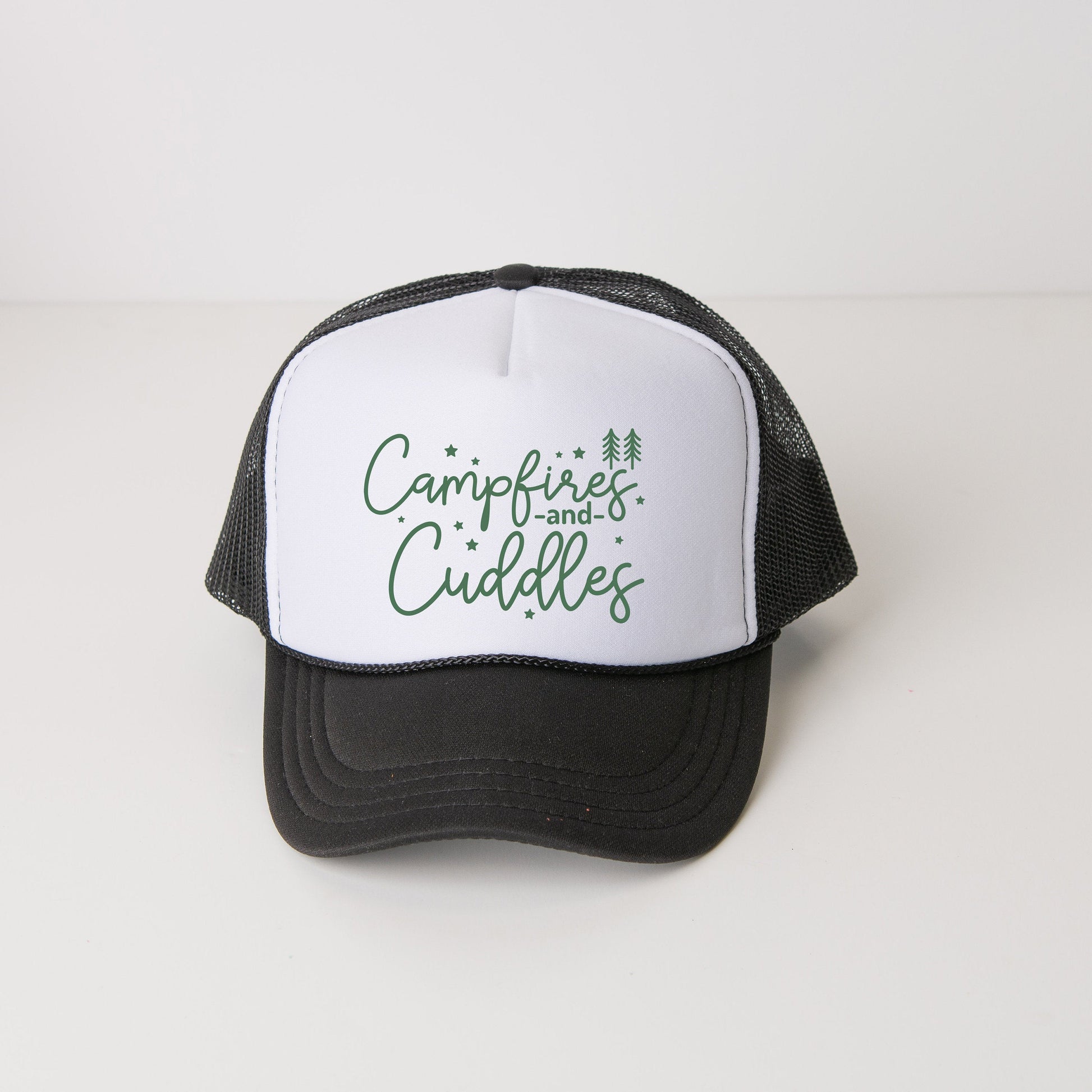 a black and white trucker hat with the words campfire and cuddles