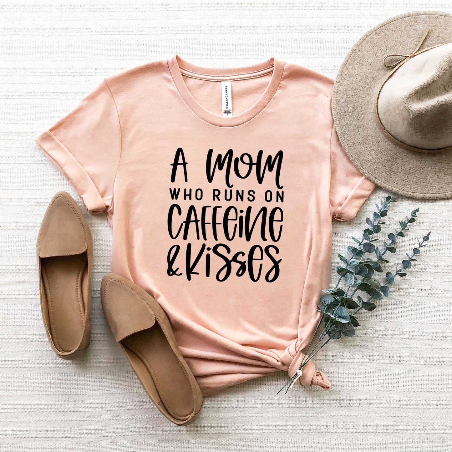 A Mom Who Runs On Caffeine And Kisses | Short Sleeve Crew Neck